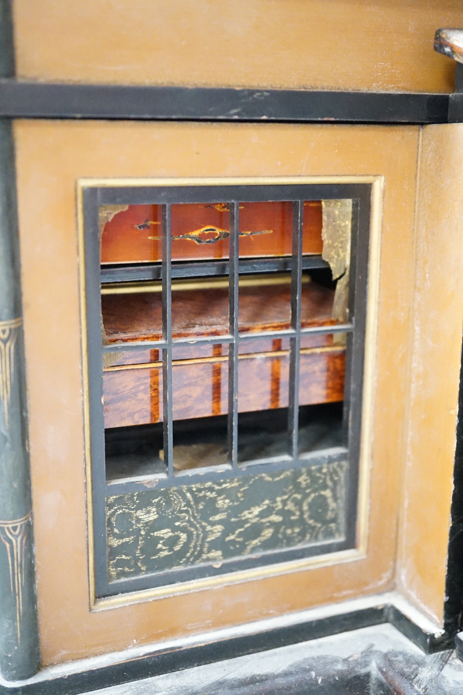 A Japanese lacquer 'house' with pitched wicker roof and opening side and front sections revealing internal shelves and six lacquer boxes and a small glass painted panel, ‘house’ height 28.5 cms high